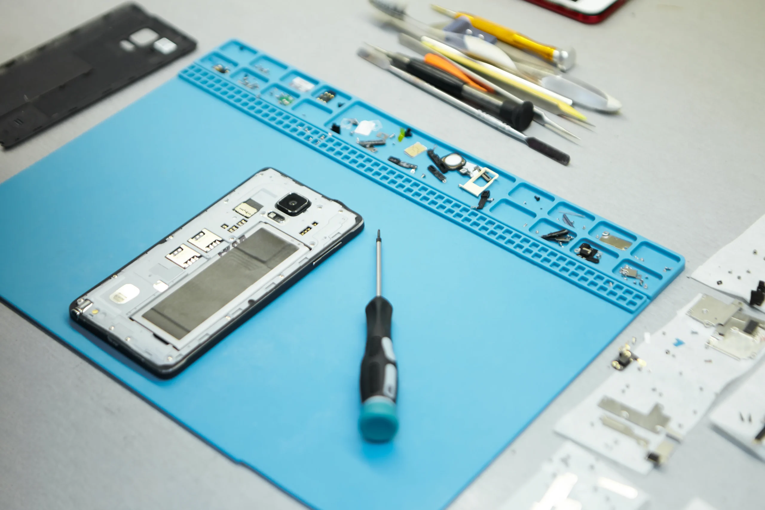 repairman-s-workplace-with-cell-phone-special-tools-desk